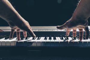 male-hands-play-piano-keys-dark (1)